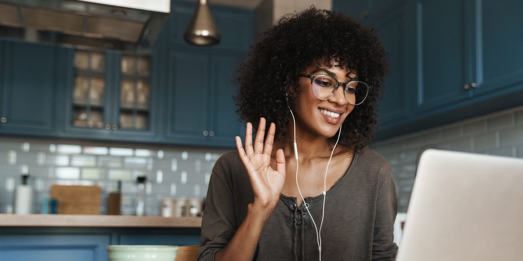 women waving at laptop